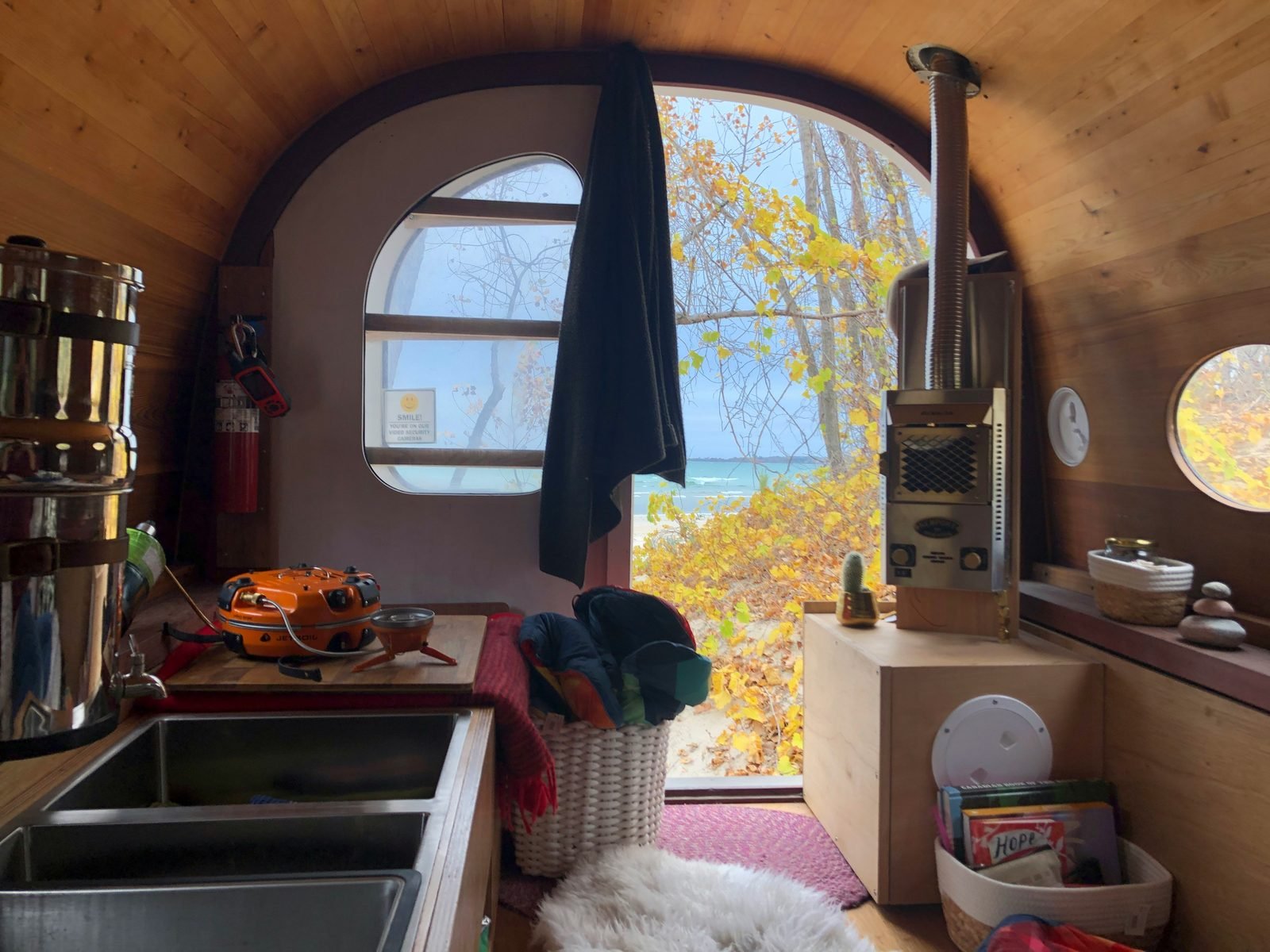 Curved interior with arched window looking out to autumn lake