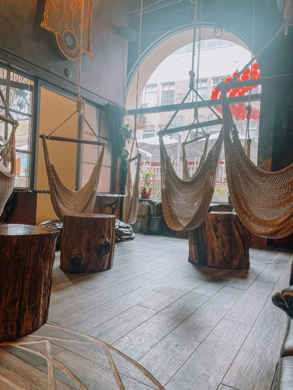 Hanging hammock chairs in an arched space — the volunteer dormitory