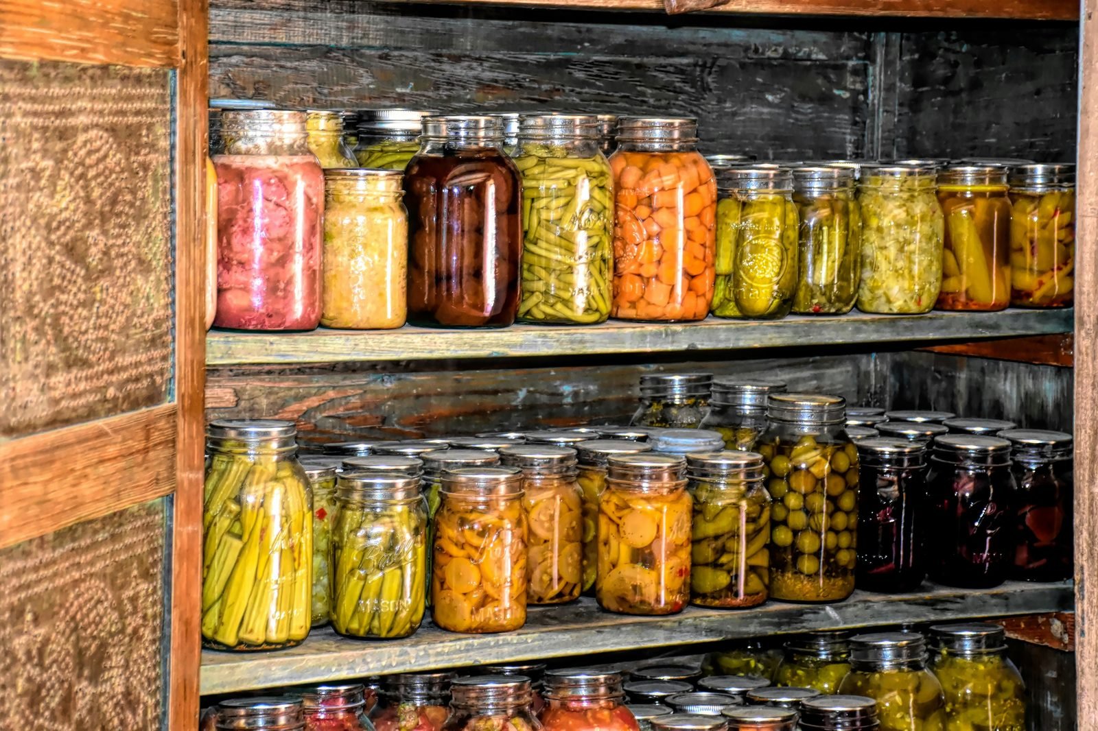 Shelves of preserved vegetables in mason jars