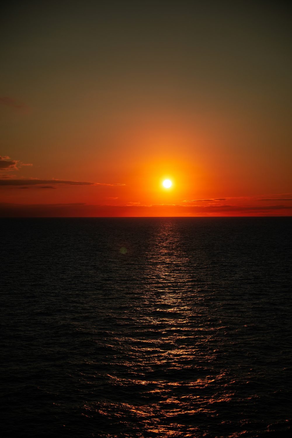 A red sun on the horizon — the threshold between worlds