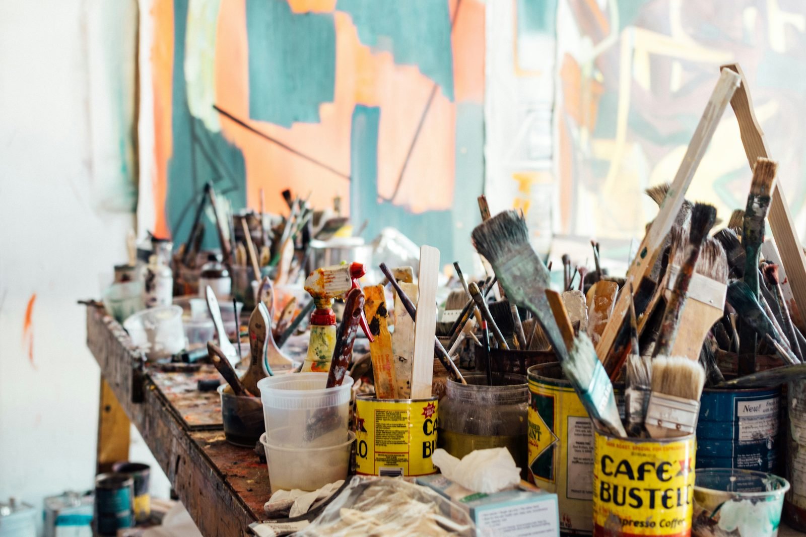 Painting studio with brushes and colourful canvases