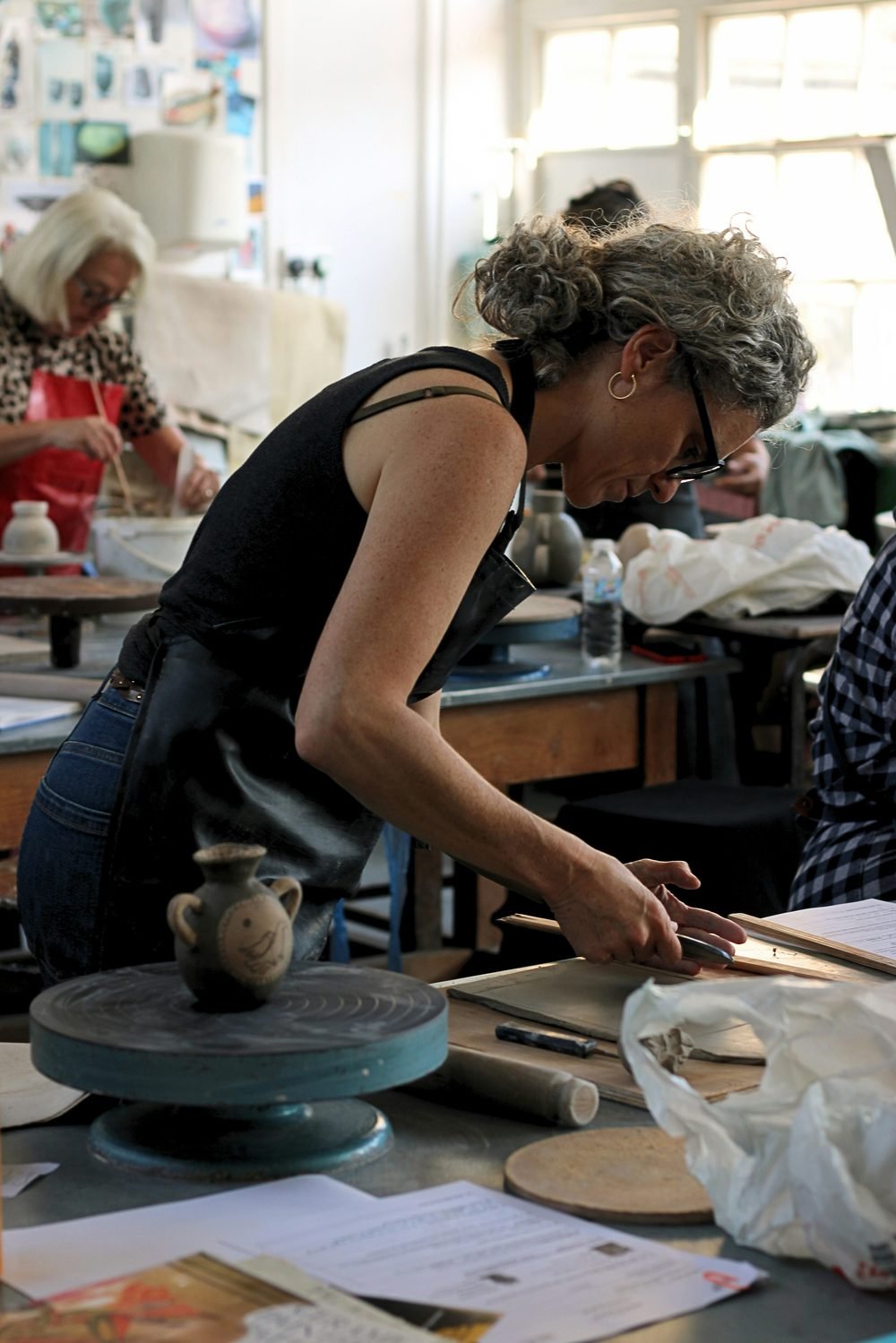 Ceramics class, woman working with clay