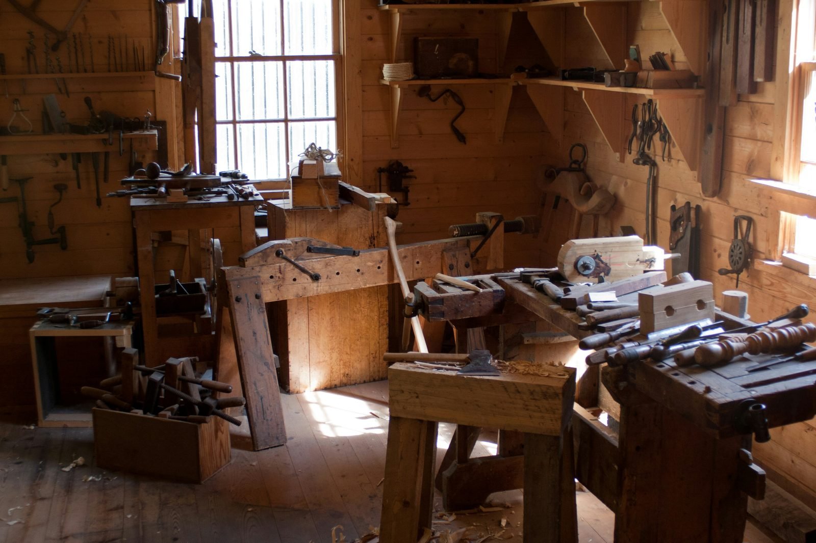 Large daylit woodworking workshop, golden hour