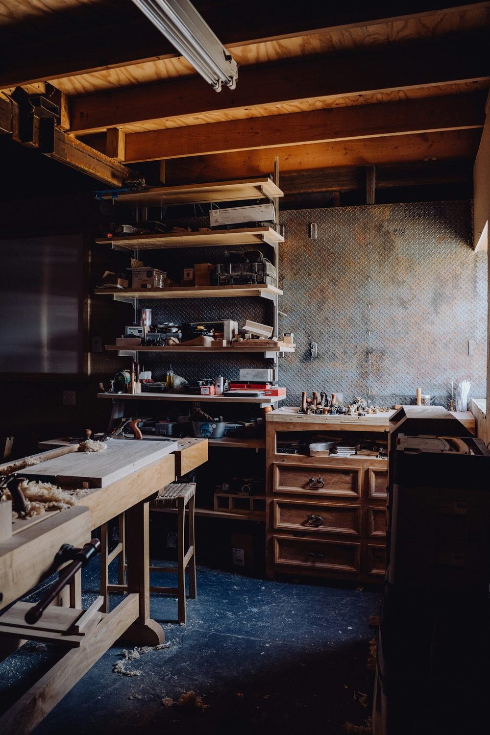 Woodworking bench with shavings, moody light